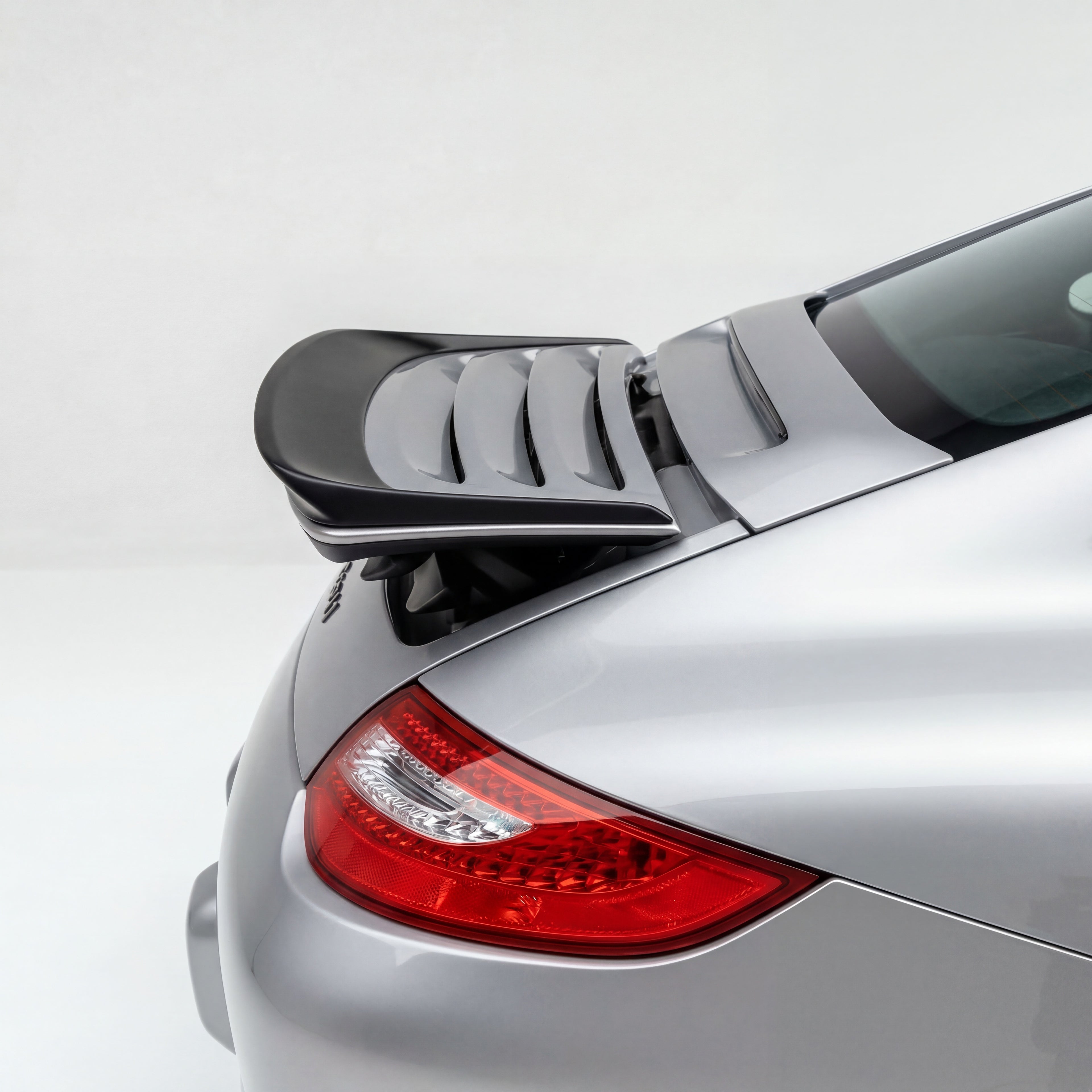 Porsche 997 Carrera GT3TEK rear wing by BetterBodies Motorsport, polyurethane ducktail spoiler on a 2005–2012 sports car.