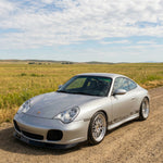 Silver Porsche 996 Turbo front lip spoiler by BetterBodies Motorsport, racing style upgrade for enhanced front bumper appearance.