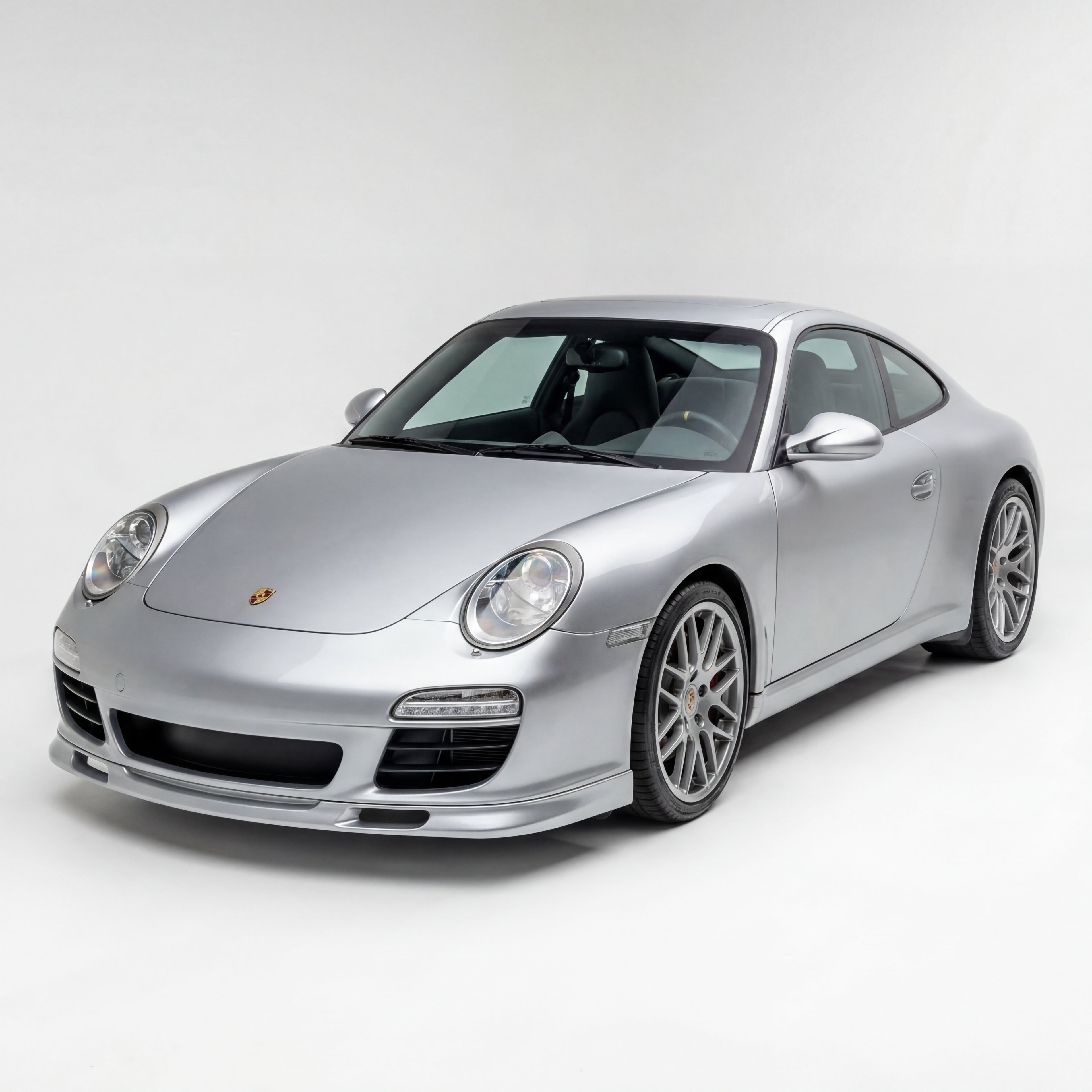 Porsche 997.2 front lip spoiler in polyurethane GT3-style for 2009–2012, installed on the front of the car, with no license plate visible.