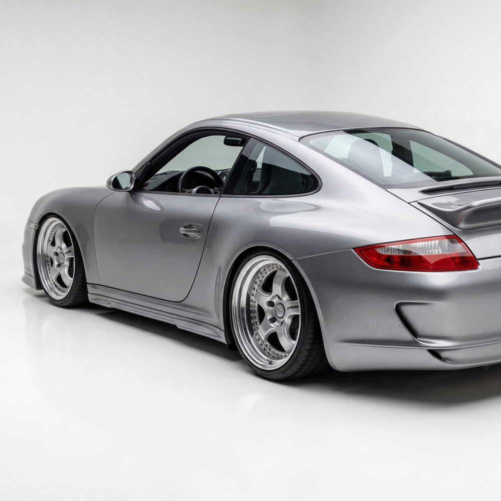 BetterBodies Motorsport polyurethane side skirts for Porsche 997 Carrera Mach II narrow body, 2005–2012, shown installed on the car.