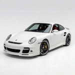 Polyurethane widebody front bumper lip for Porsche 997 Turbo, 2007–2009, by BetterBodies Motorsport, shown on a sleek car.